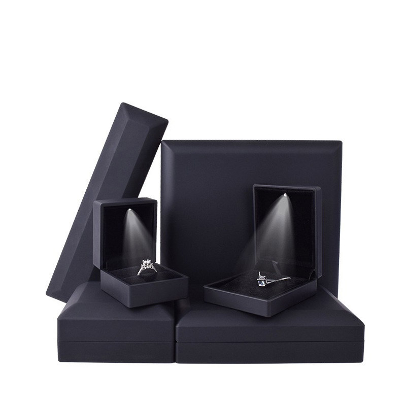 Black LED jewelry boxes in ring, pendant and bar formats with a lit necklace
