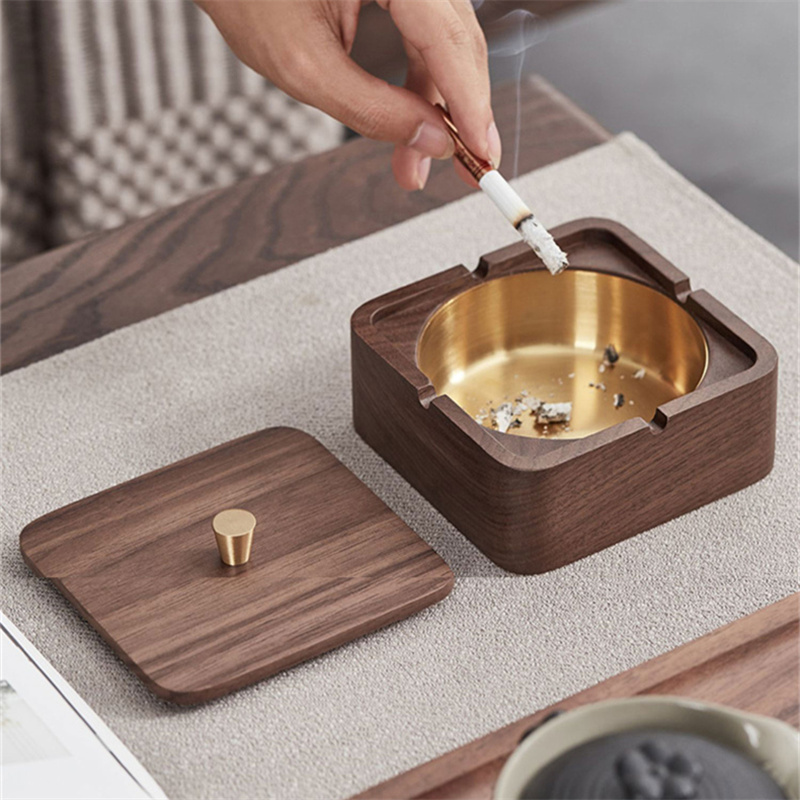 Walnut ashtray with lid closed and brass conical knob on top