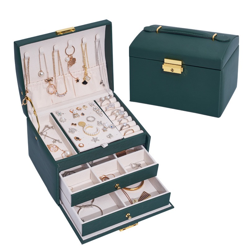 Close-up of gold-tone latch on pebbled faux leather jewelry case