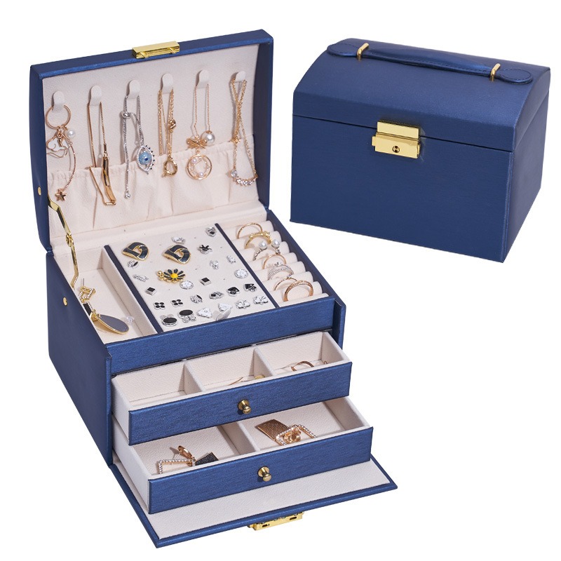 Navy jewelry box interior with stud panel, ring slots and drawers