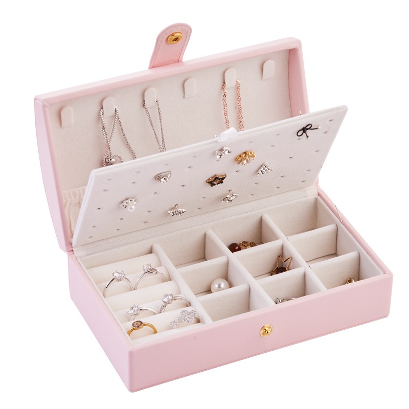Rings seated upright in the slotted ring row of a jewelry box