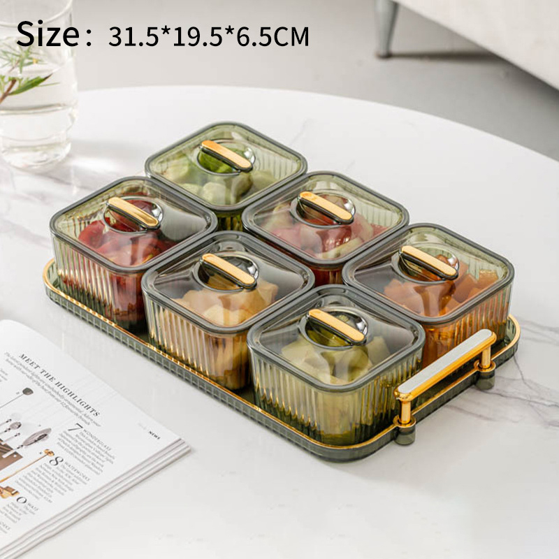 Smoke green 6-compartment tray with gold lids on a marble table
