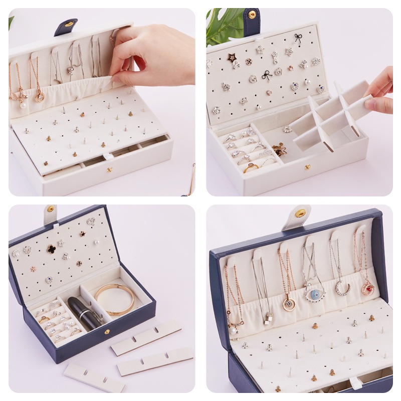 Hand lifting necklaces from the hooks inside a cream jewelry box