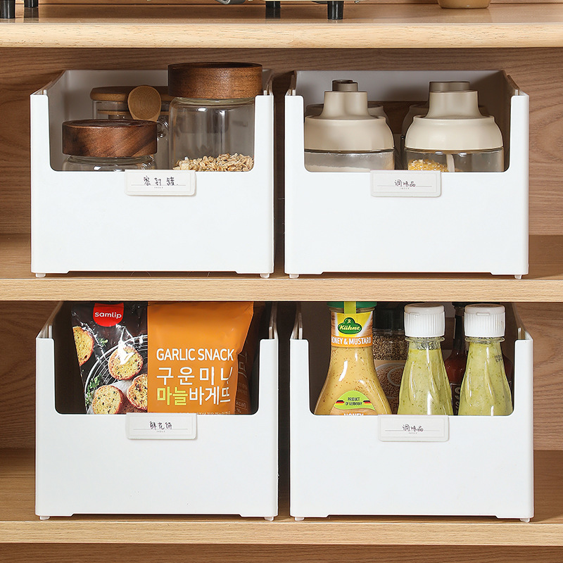Four white open-front bins holding jars, condiments and snacks on pantry shelves