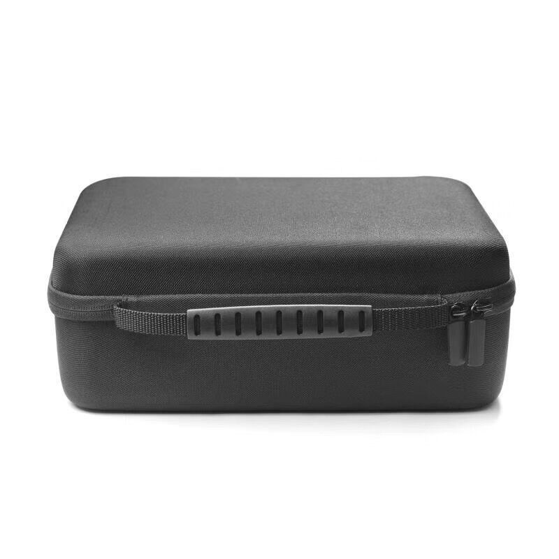 Black travel case photographed beside everyday items before packing
