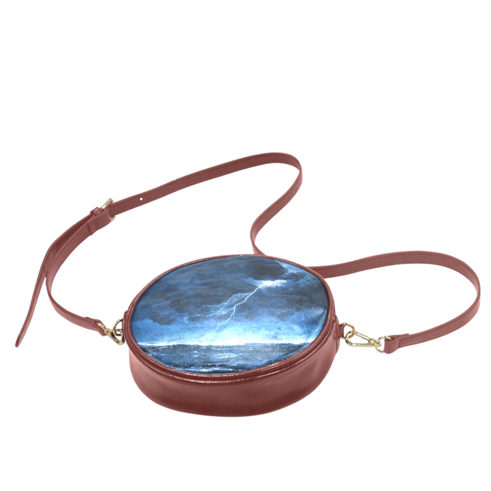 Round PU leather messenger bag with unique print, adjustable strap, single zip closure. Ideal for women.