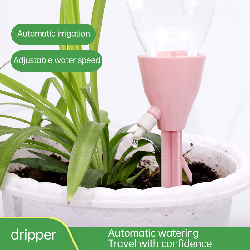 Soft pink drip spike in a white planter during an automatic watering setup