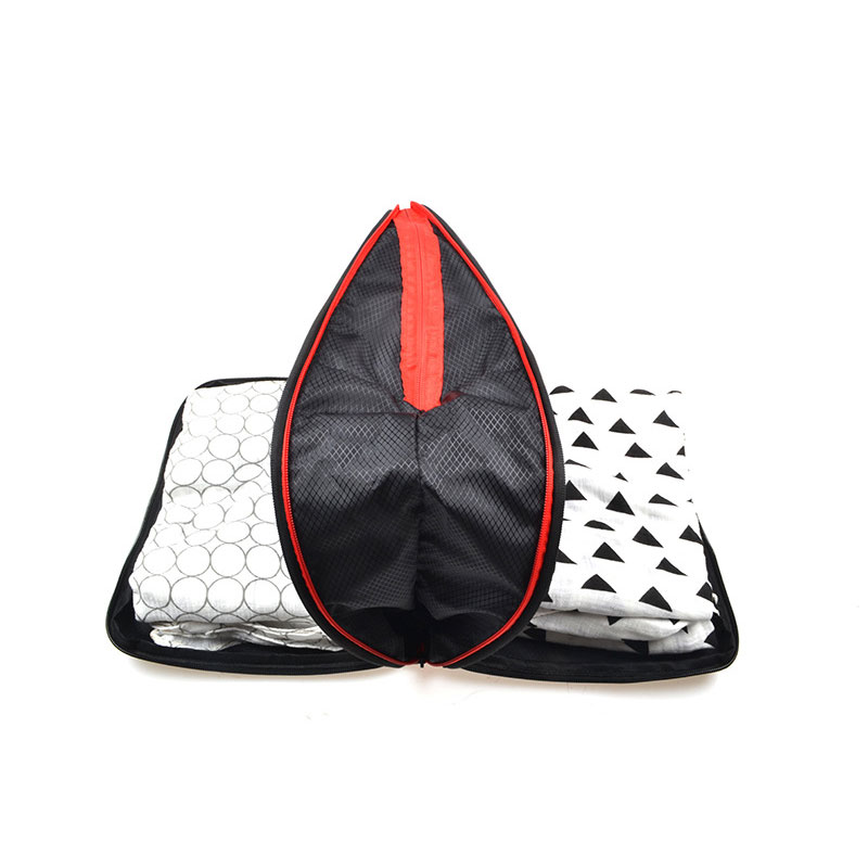 Teardrop mesh bag with red zipper between two cubes holding folded clothes