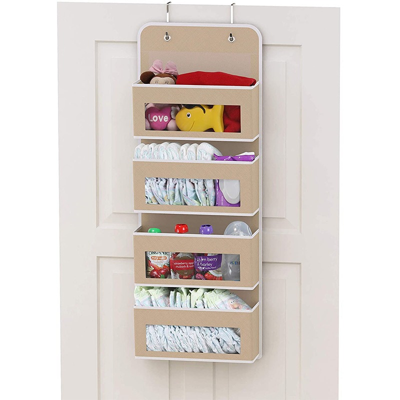 Tan over-door organizer with metal hooks at the top and white trim, filled with baby items