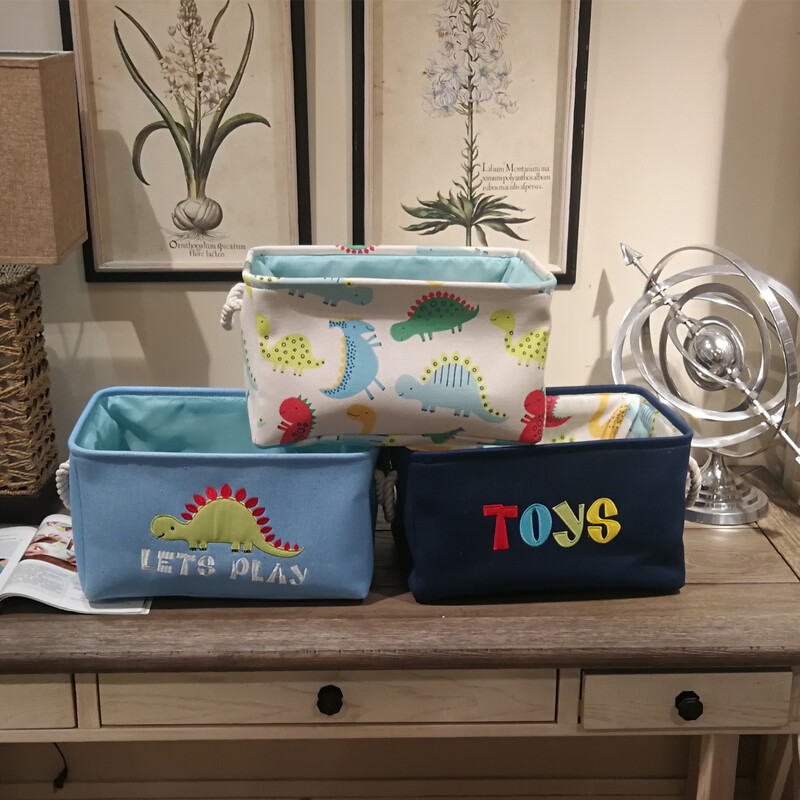 Front-facing lineup of three canvas storage baskets with thick white rope handles