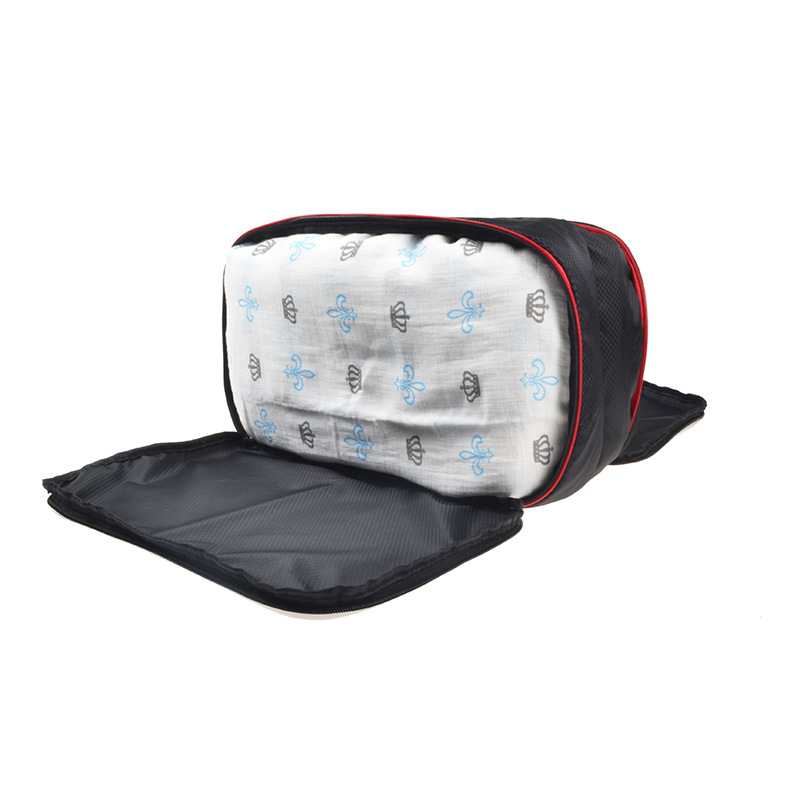 Open packing cube showing mesh lining and folded patterned clothing inside