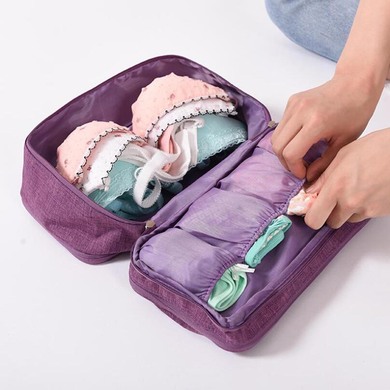 Packed suitcase with loose underwear and bras pushed between clothes