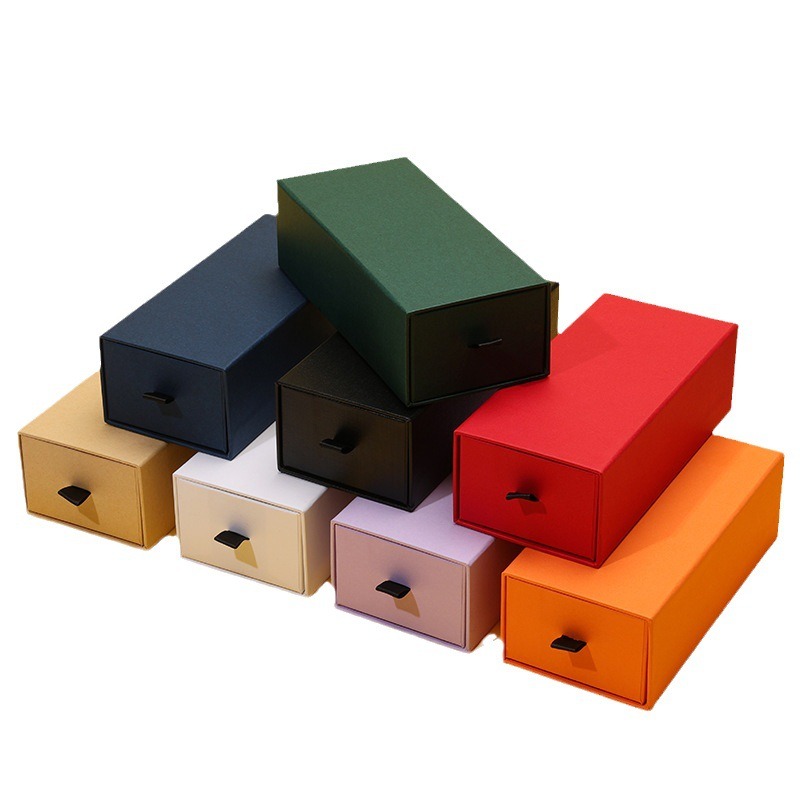 Stacked matte kraft drawer boxes in several colourways