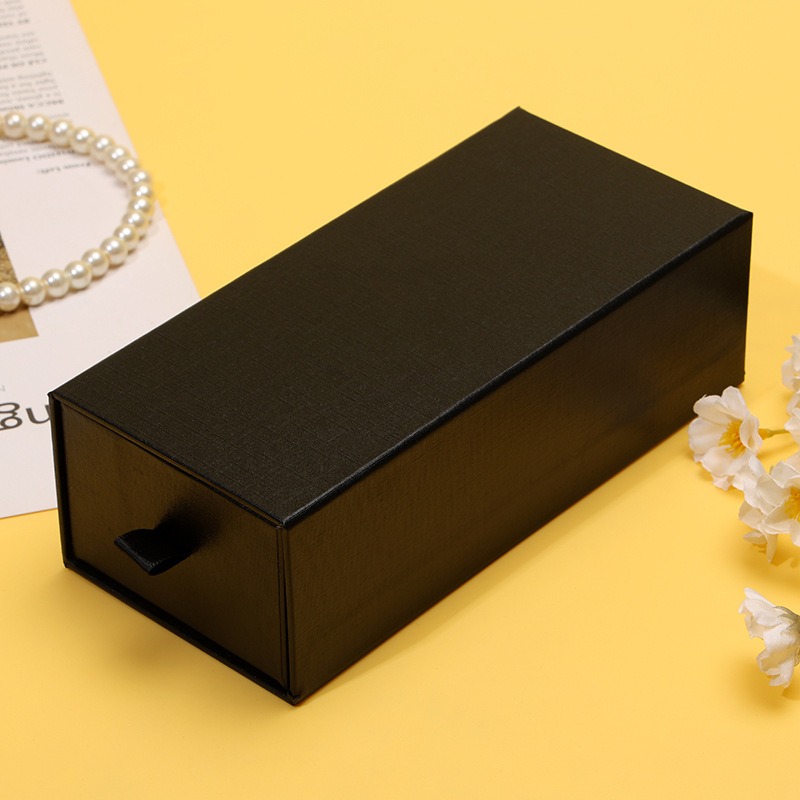 Slim gift sitting loose in a generic paper bag