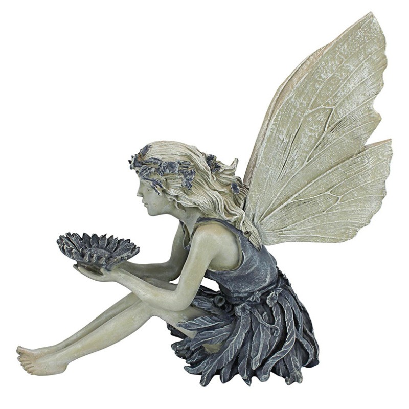 Rear view of resin fairy statue with wings raised