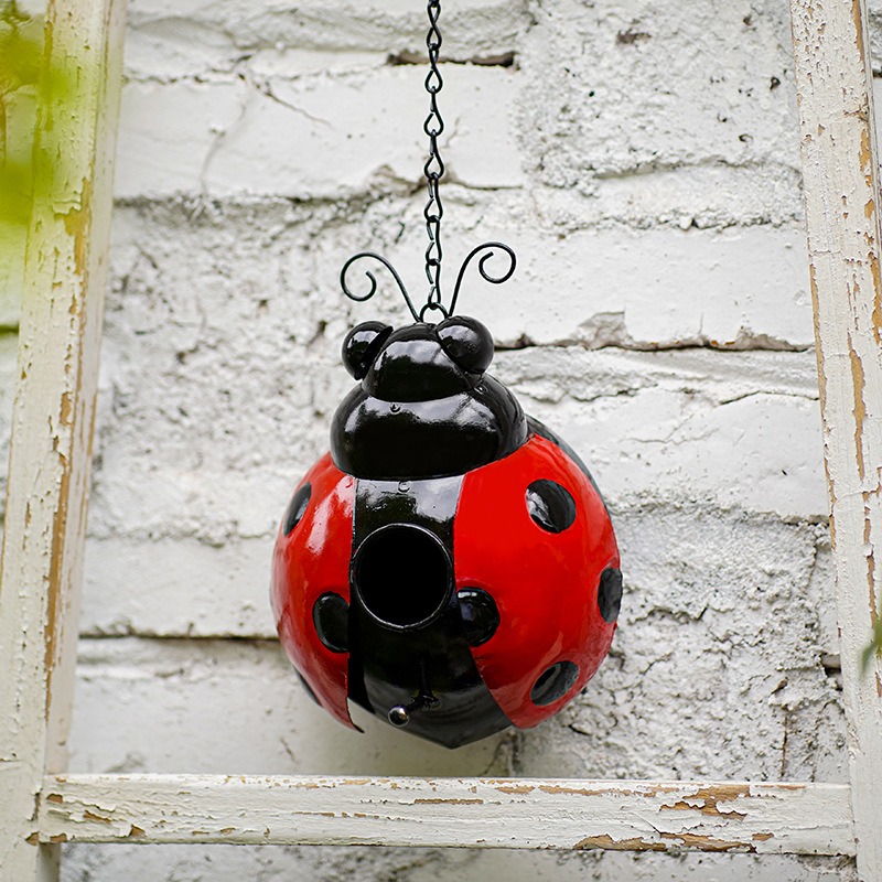 Bumblebee bird house hanging in a bright garden for winter