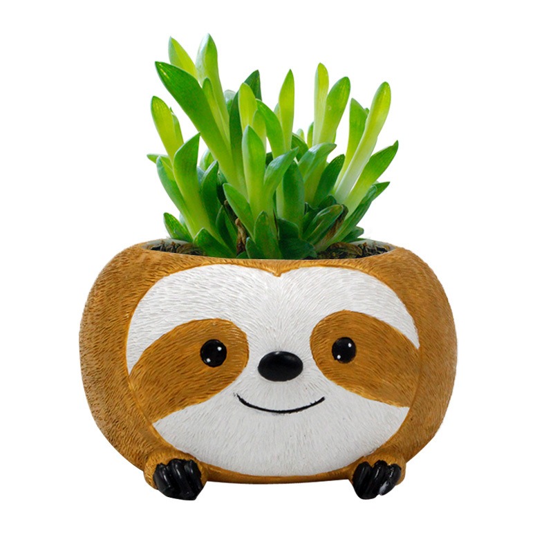 Sloth planter with green succulent growing on a desk