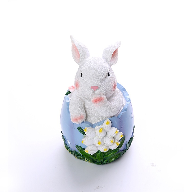 Powder blue resin bunny with paw and ear detail and white flowers