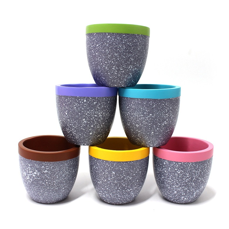 Six empty speckled resin pots stacked in a pyramid showing rim colors