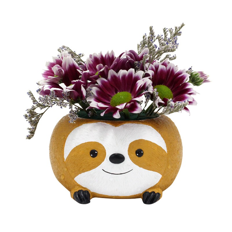 Sloth planter filled with chrysanthemums and lavender sprigs