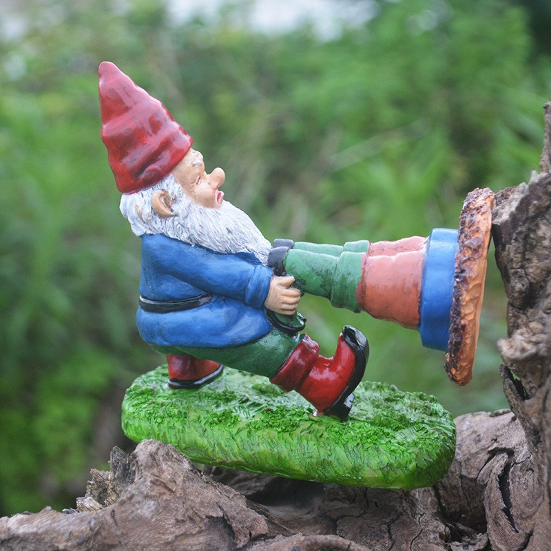 Gnome figurine resting on weathered wood with leafy background