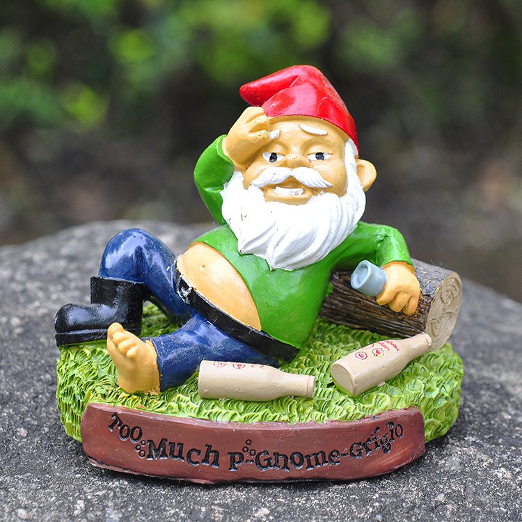 Gnome statue set in an outdoor garden display with greenery behind