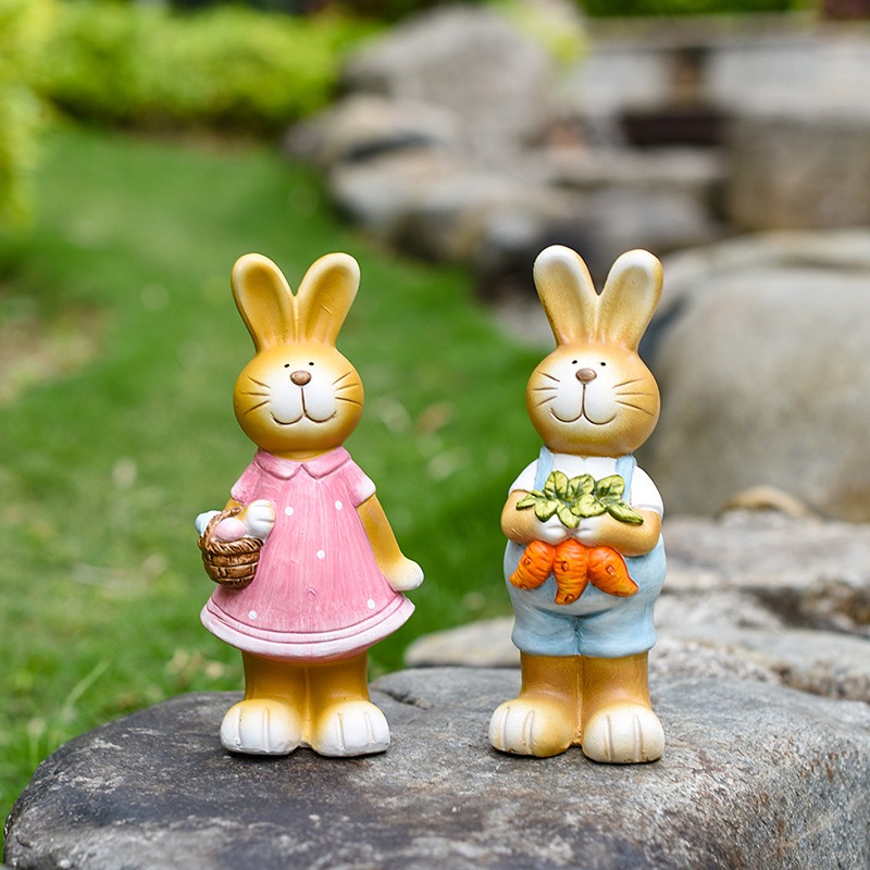 Ceramic garden bunny figurine set in an outdoor garden setting