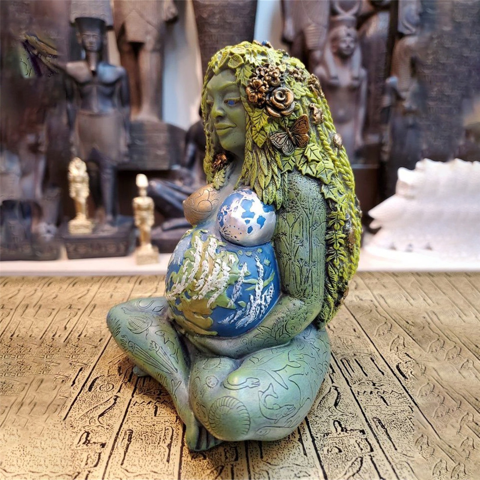 Gaia statue photographed at a three-quarter angle showing sculpted back details