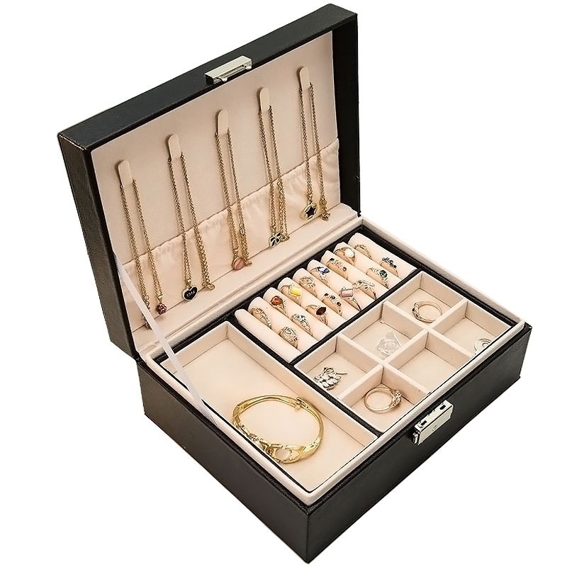 Black leather-look jewelry box open with necklaces hung in the lid