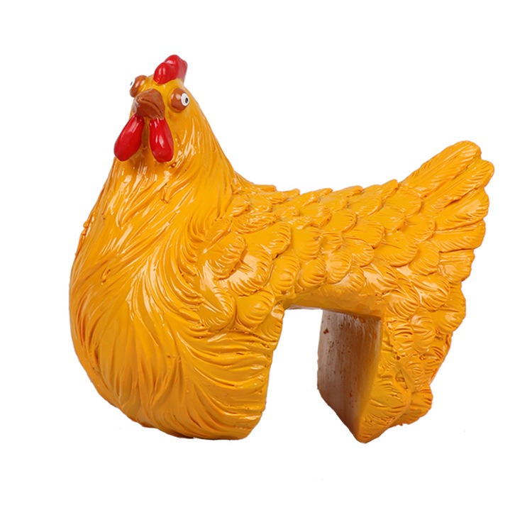 Mustard-yellow resin hen with sculpted feathers and clamp opening