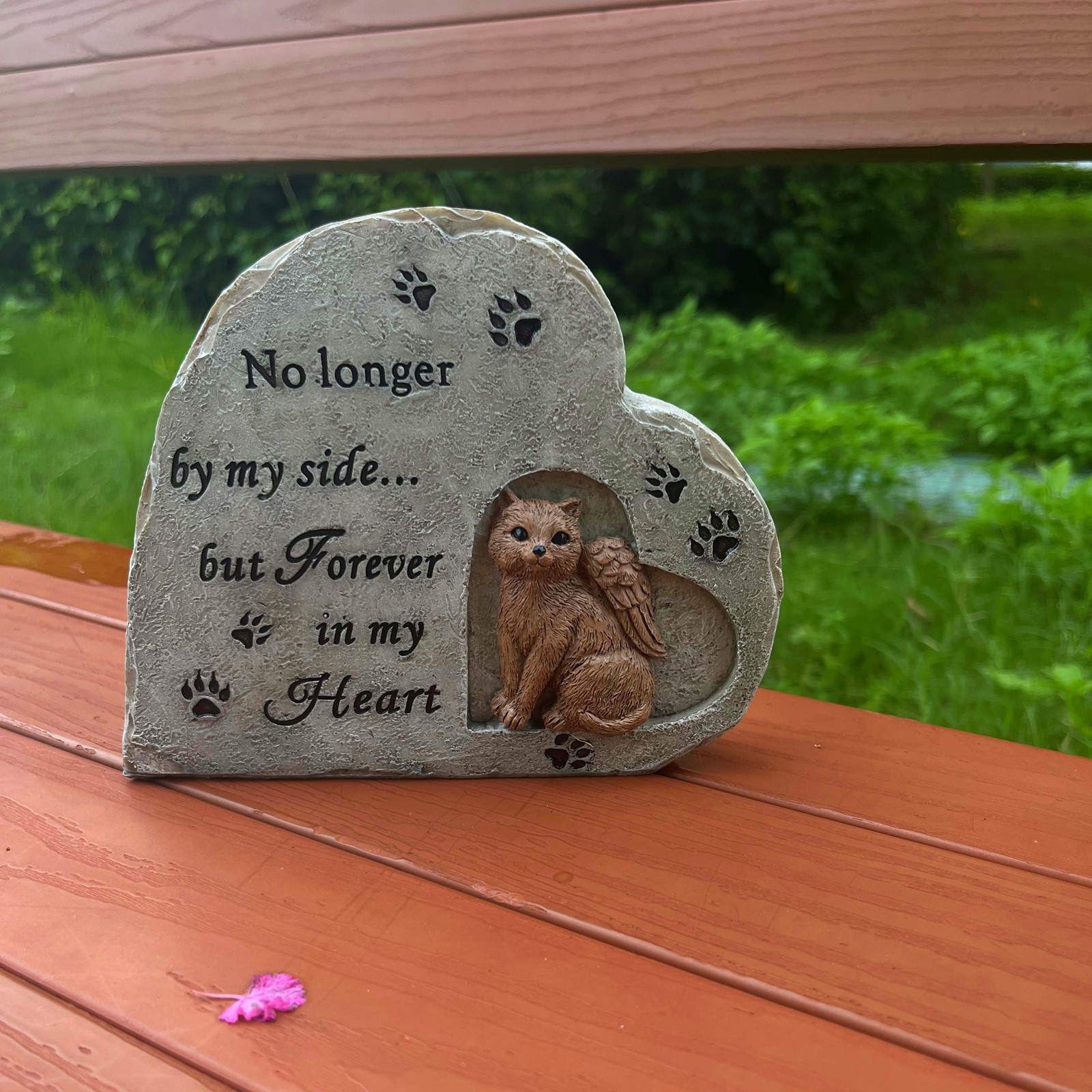 Close-up of raised cat sculpt with angel wing in a heart recess and paw prints
