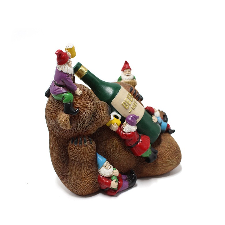 Side view of the bear sculpture with bottle and gnomes in profile