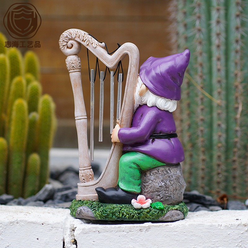 Gnome wind chime figure in a garden with chime tubes hanging from the harp