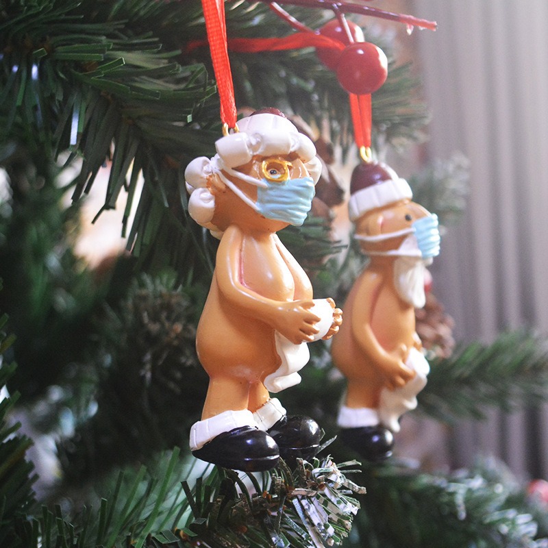 Santa ornament with blue face mask and toilet paper roll in hand