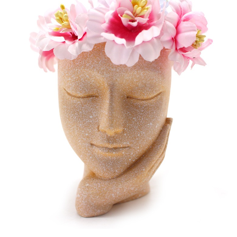 Close-up of face planter with pink blossoms in the open crown