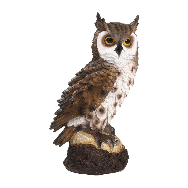 Brown resin owl with spotted chest and yellow eyes on a stump