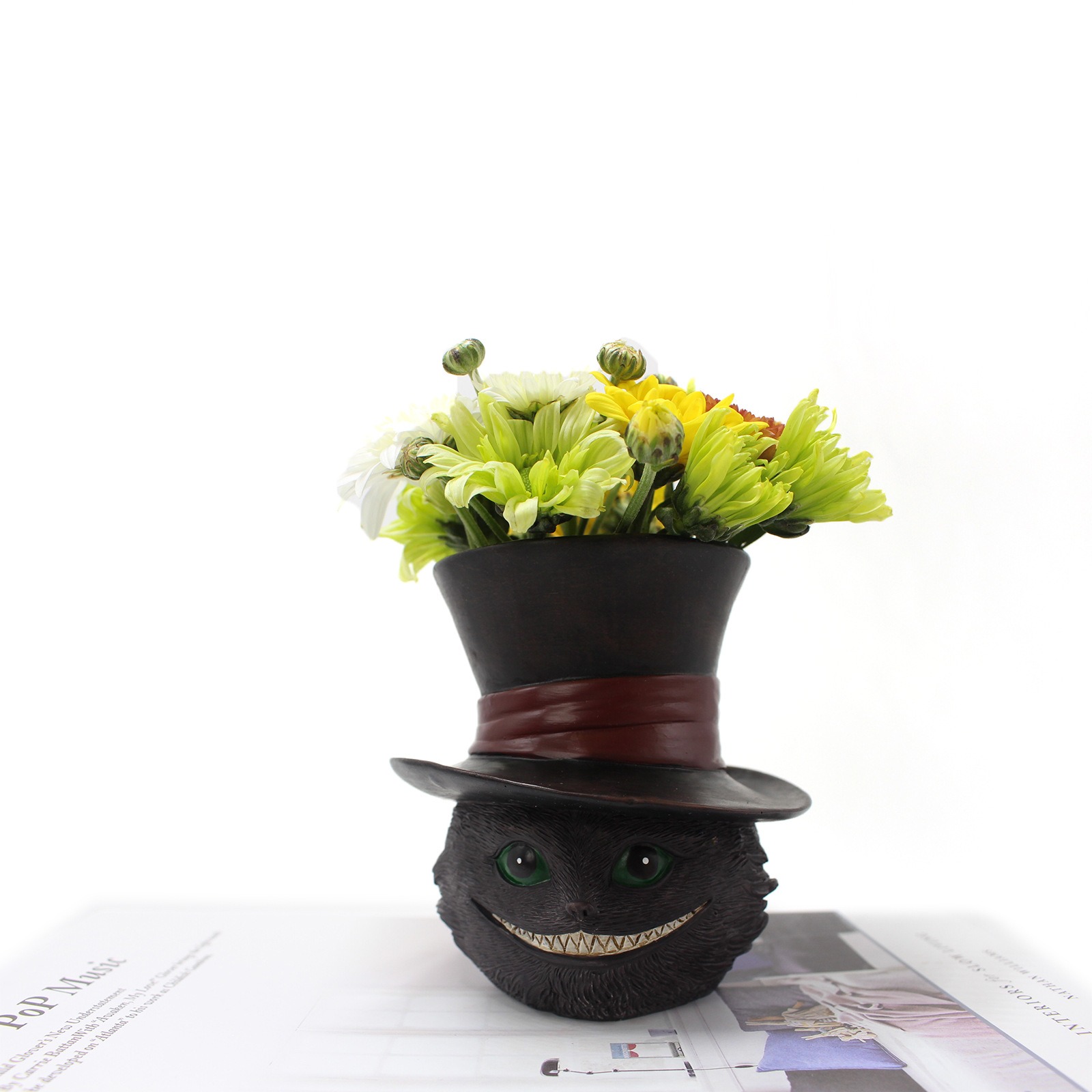 Cat planter filled with fresh yellow and green chrysanthemums