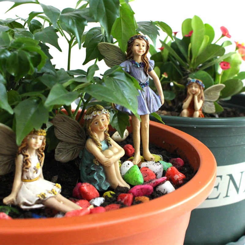 Six resin fairies with painted faces and floral crowns