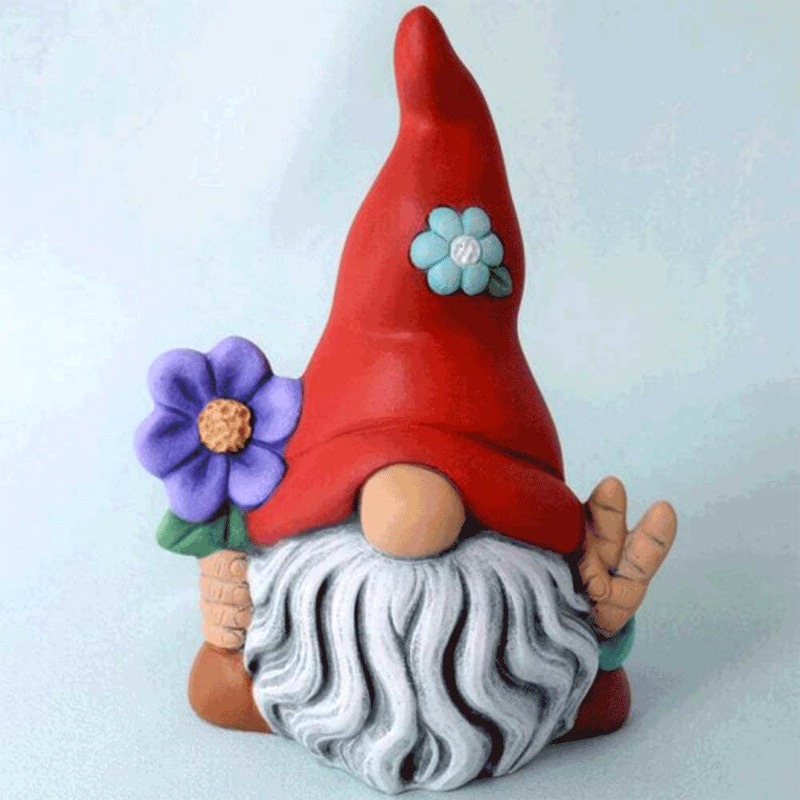 Side view of a garden figure set beside a bed edge