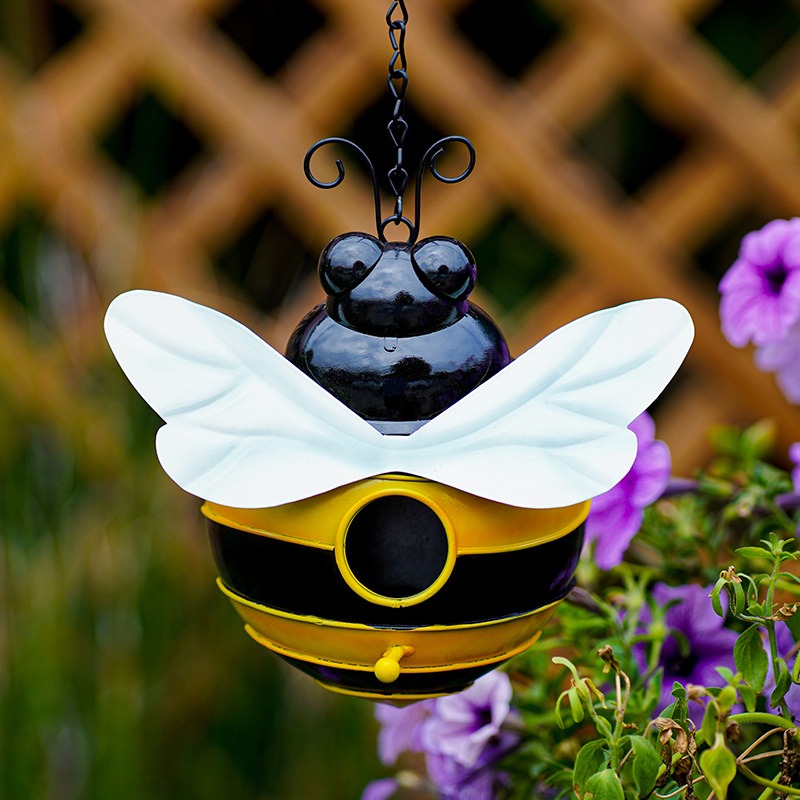 Bumblebee bird house with glossy stripes and curled antennae in a garden