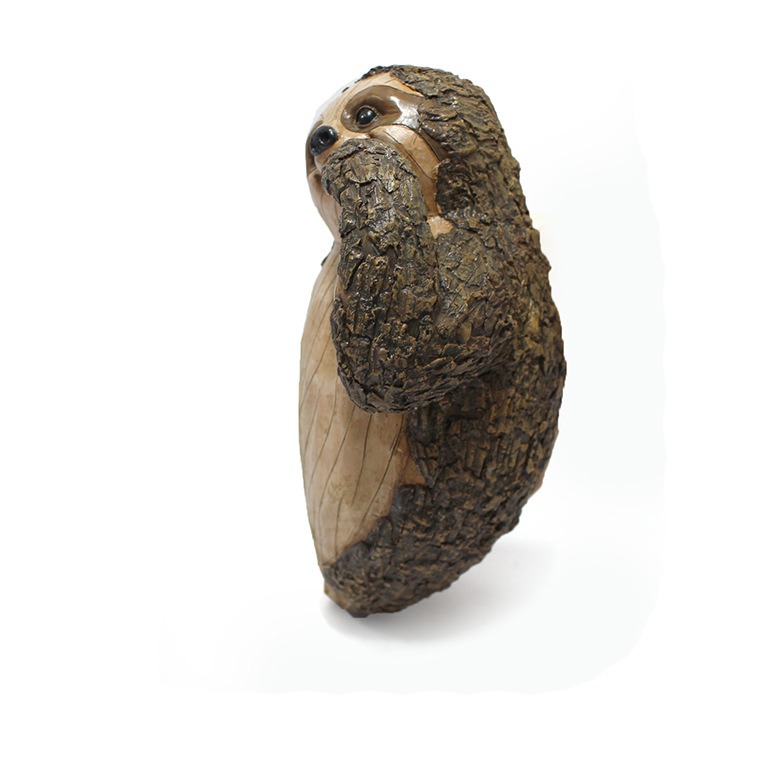 Back view of resin sloth showing bark-textured surface and depth