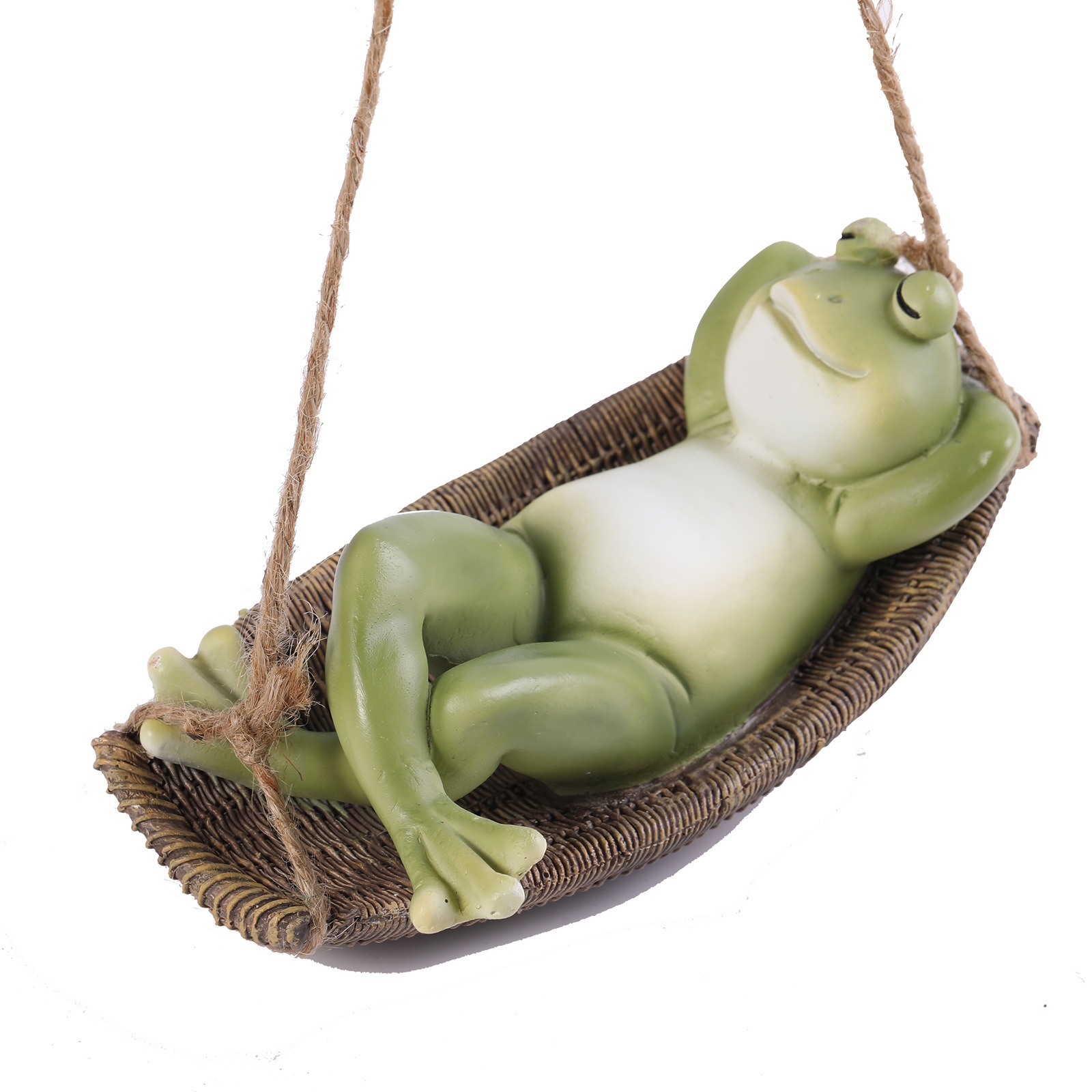 Close-up of a green and cream frog figure relaxing in a brown woven seat
