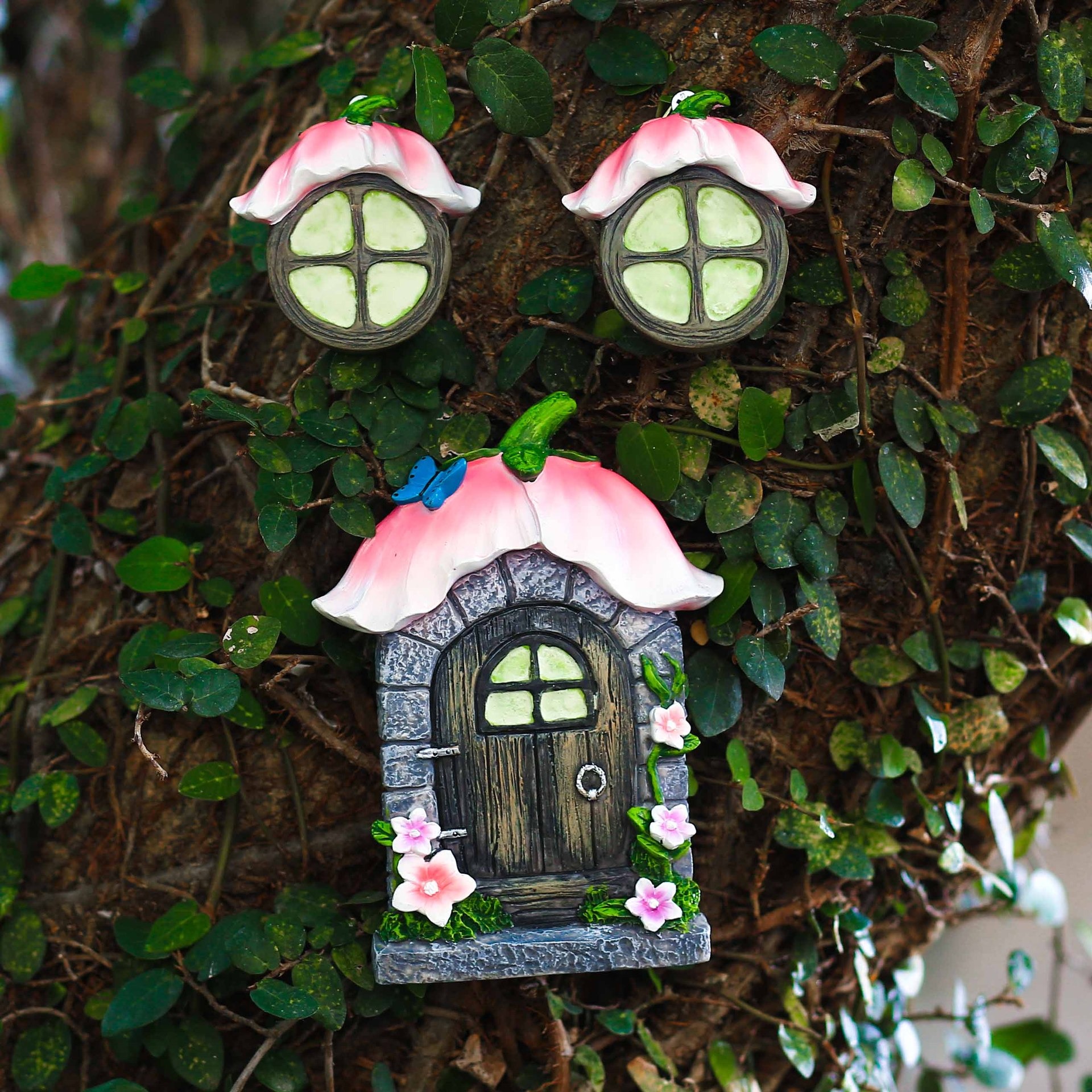 Garden scene with a fairy door on a tree trunk at child height