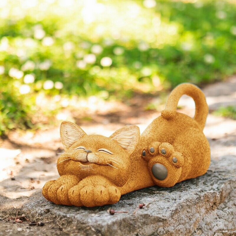 Resin cat figurine resting in a relaxed pose for a garden display