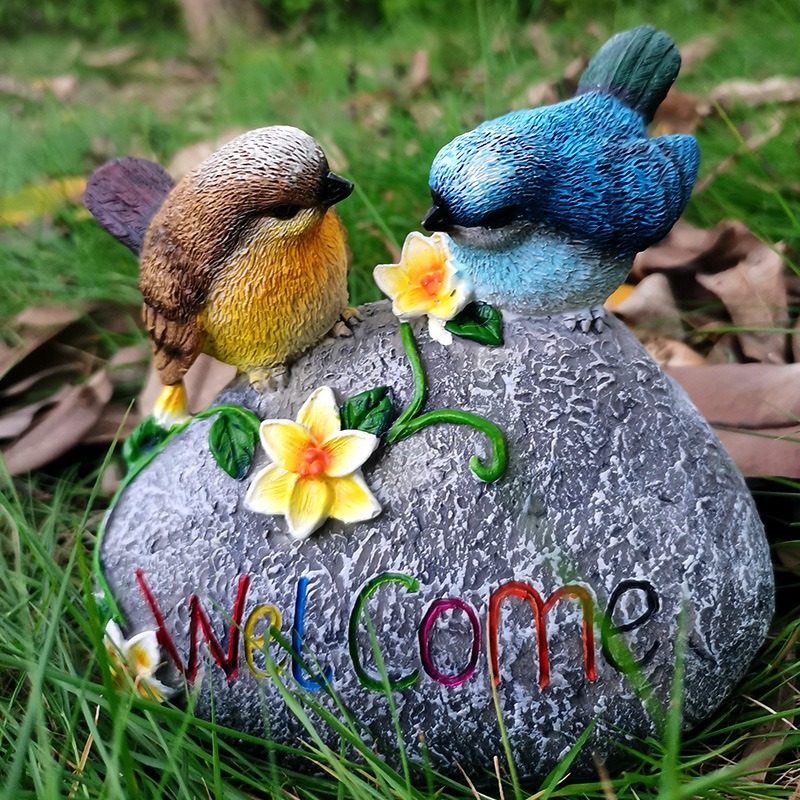 Resin garden bird with painted feather detail on a stone base