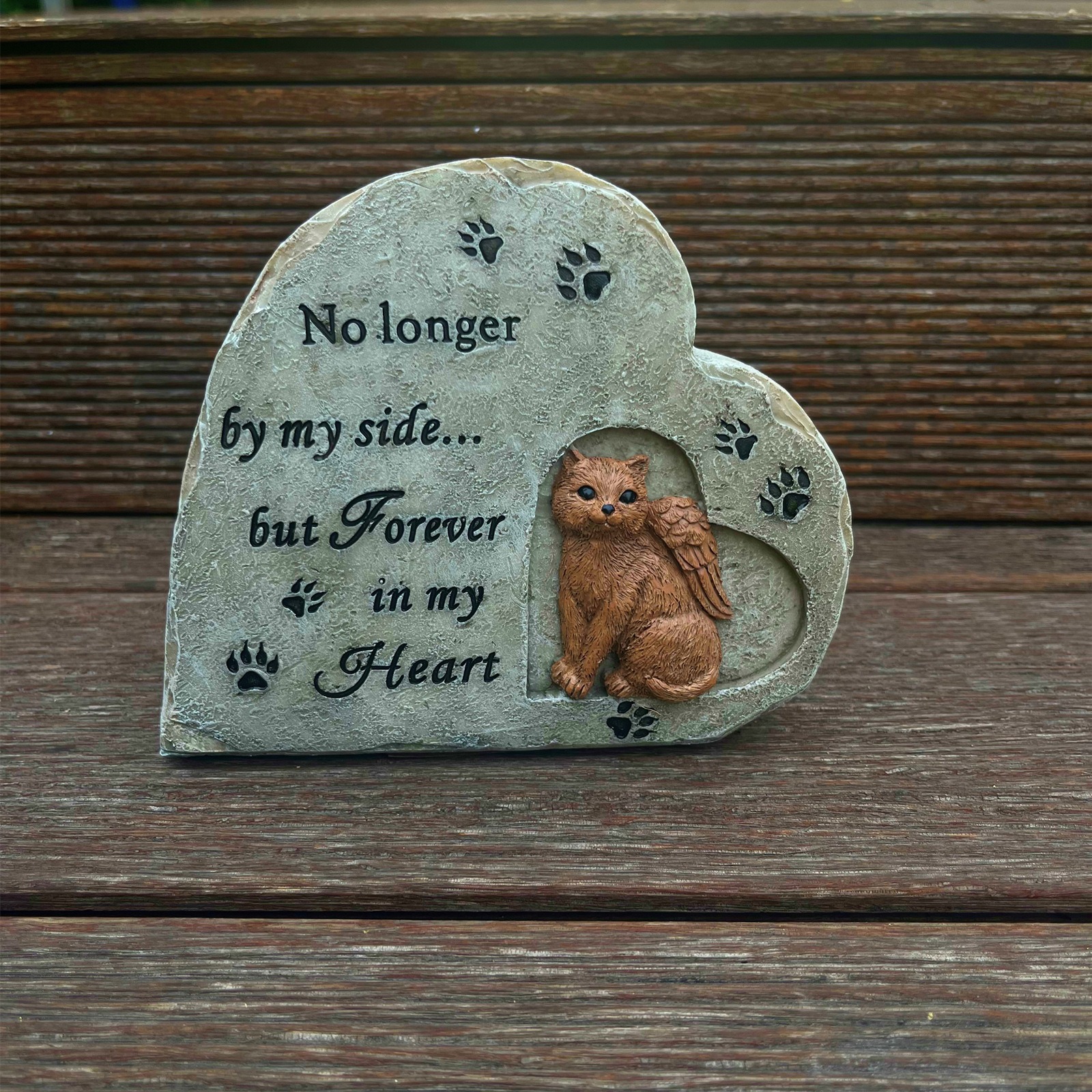 Heart-shaped memorial stone with a sculpted cat and angel wings, front view