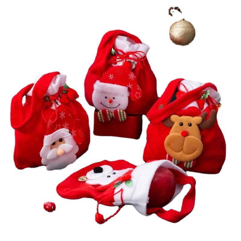 Four Christmas bags with a red apple tipped out of one bag