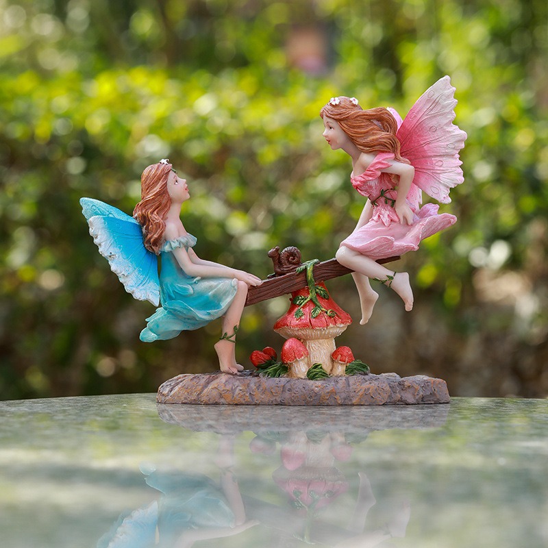 Painted fairy wings with blue and pink gradient on glossy table