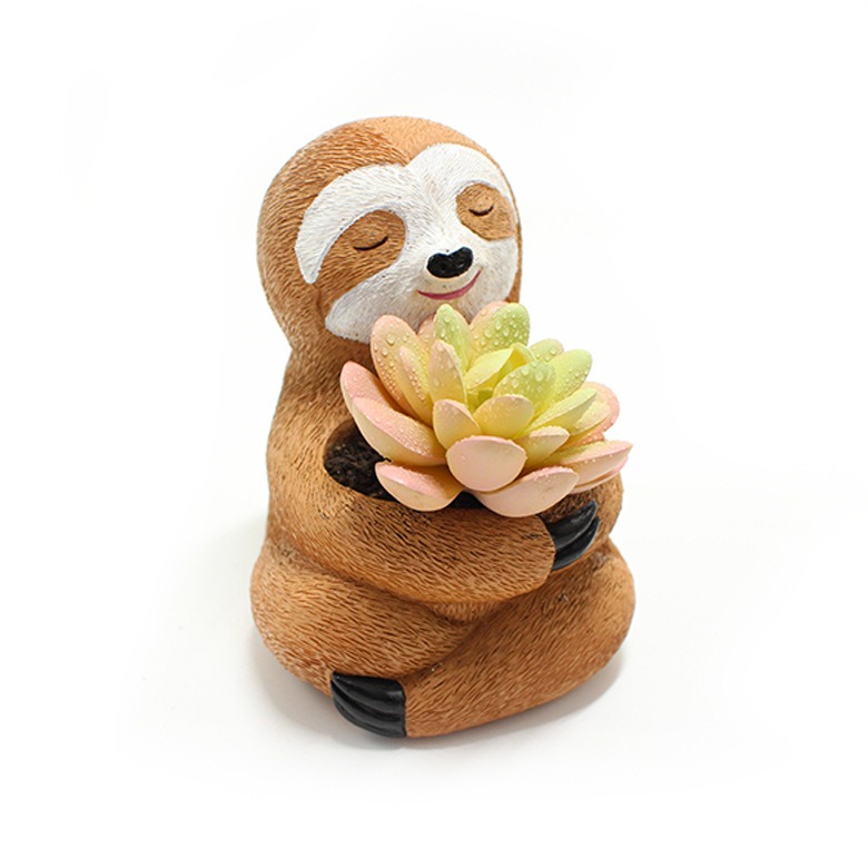 Side view of sloth planter cradling a pink-tipped faux succulent