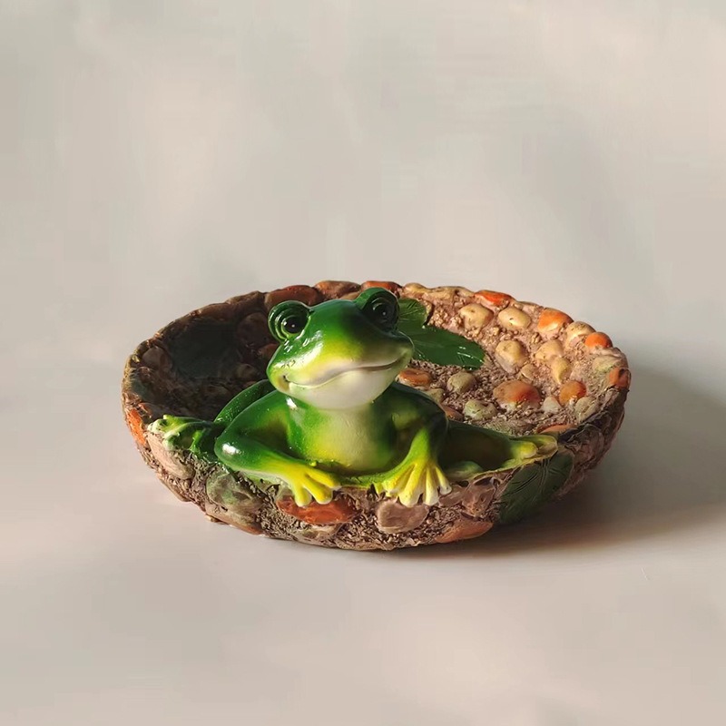 Shallow resin tray basin with sculpted stone texture on a styled surface